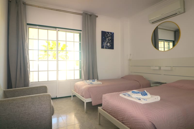 Twin bedroom with an armchair