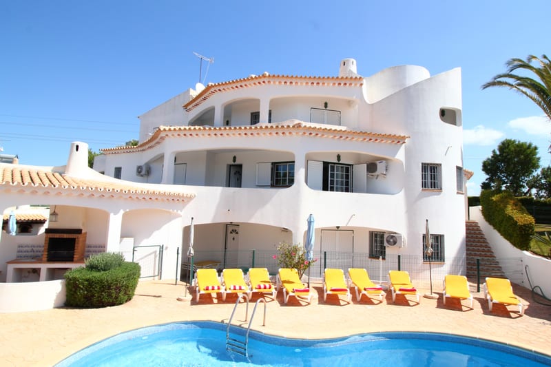 The front of the villa with the pool and loungers