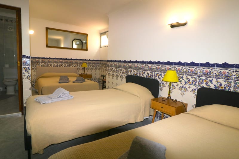 Twin bedroom with tiled walls
