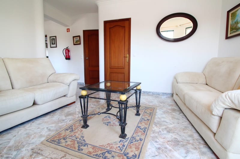 Lounge with cream sofas and a glass table