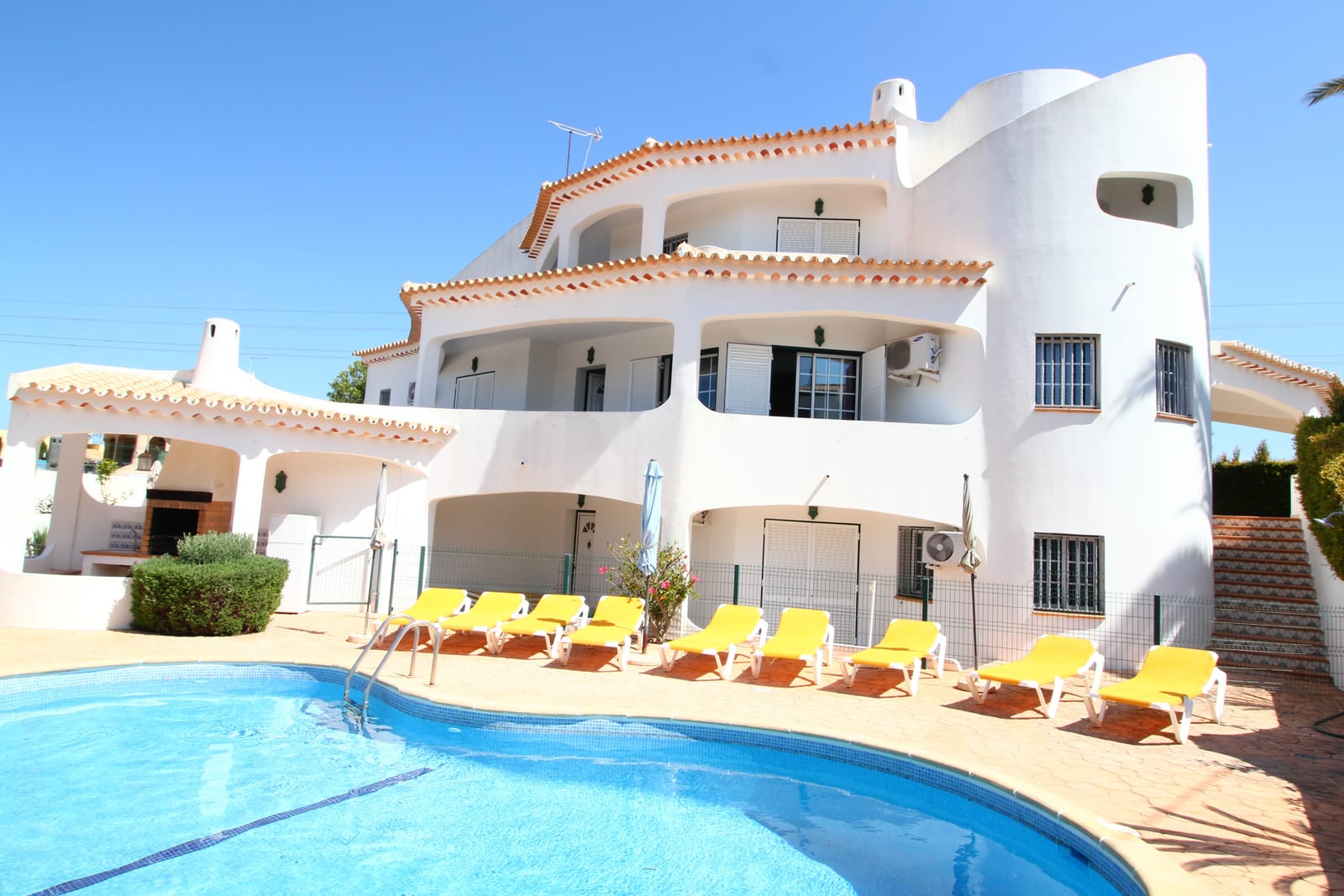 Villa Flores and its kidney-shaped pool with sun loungers