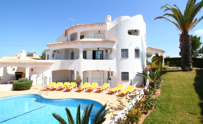 The villa and pool seen from the lawn